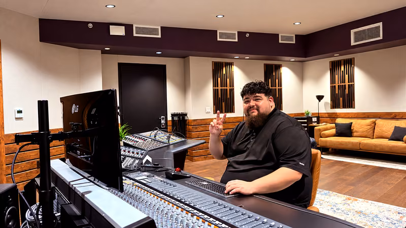Ro at the mixing console in the studio
