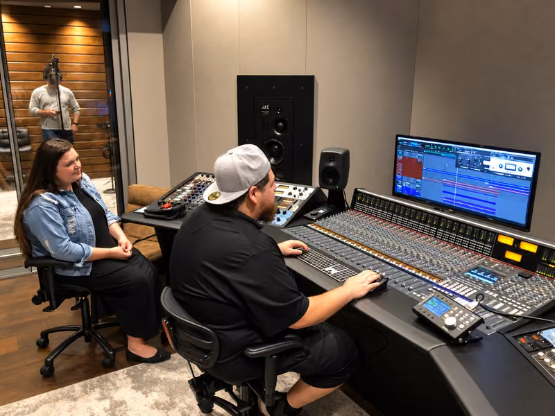 Mixing a session at the studio console with the artist